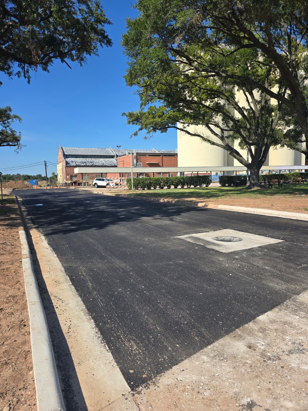 Completed asphalt surface alongside concrete curb
