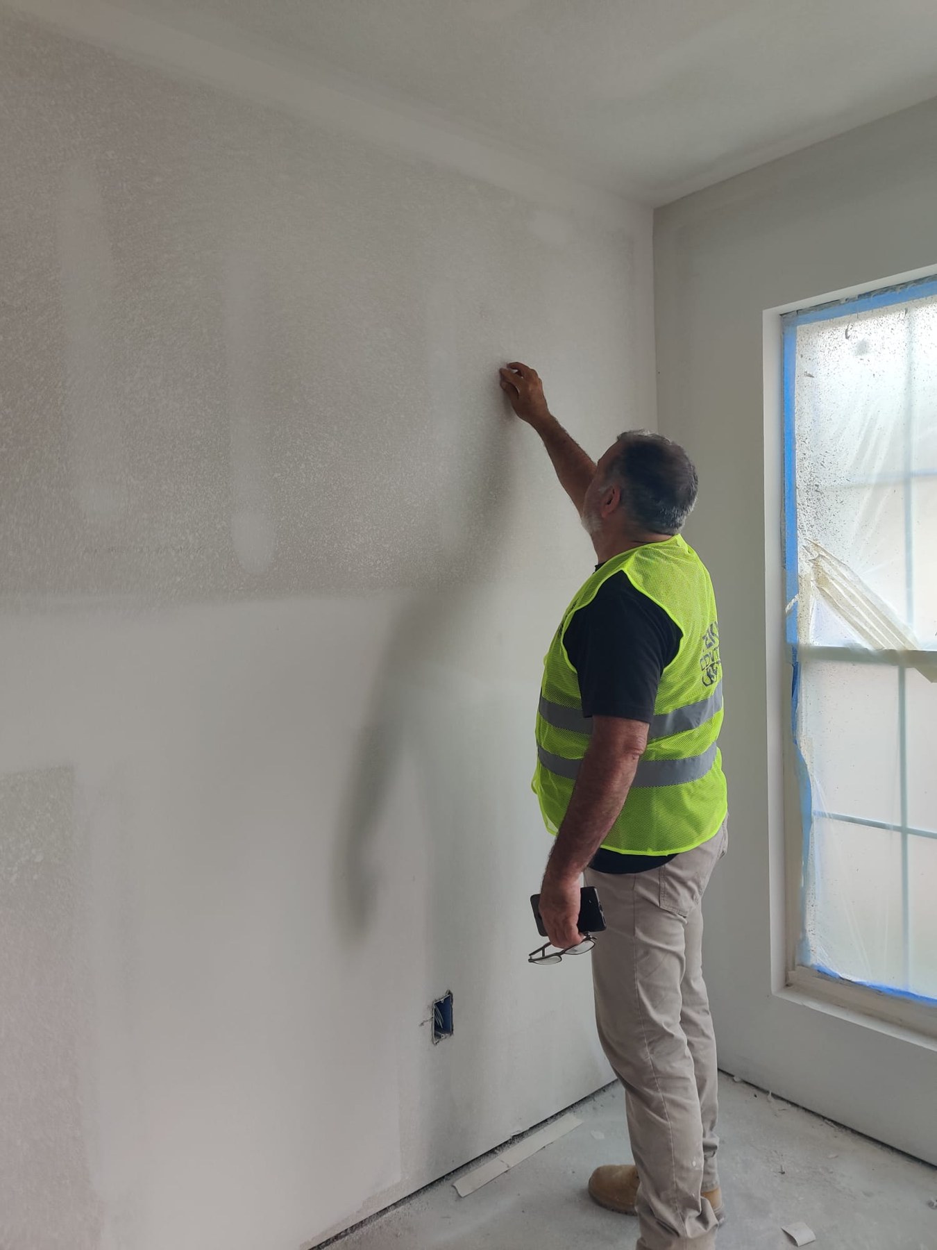 Teknor worker preparing a wall finish